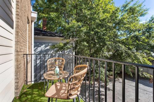 a patio with two chairs and a table on a balcony at Field of Light in Atlanta
