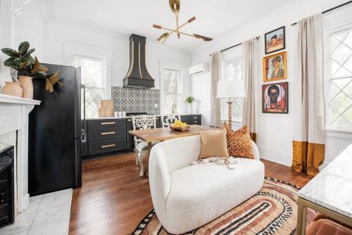 a living room with a table and a white chair at Solar Flair in Atlanta