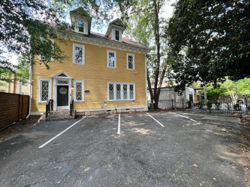 a yellow house with a parking lot in front of it at Solar Flair in Atlanta