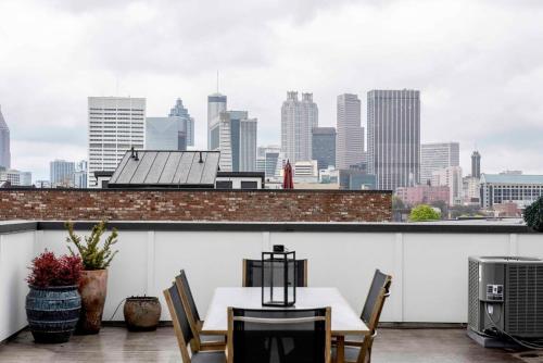 a table and chairs on a balcony with a city skyline at Bird's Eye View in Atlanta