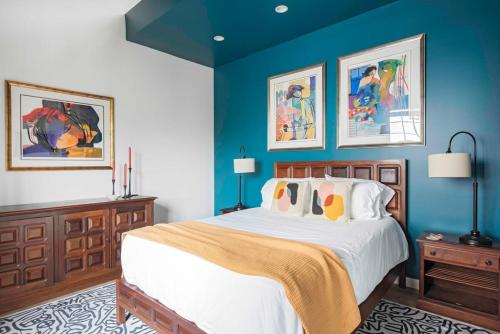 a bedroom with a large bed with blue walls at Holy Grail in Atlanta