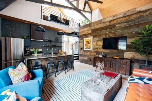 a living room with a blue couch and a kitchen at Holy Grail in Atlanta