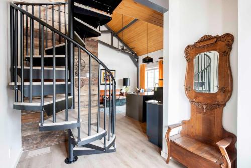 a spiral staircase in a house with a mirror at Holy Grail in Atlanta