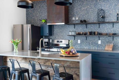 a kitchen with a counter with a bowl of fruit on it at Holy Grail in Atlanta