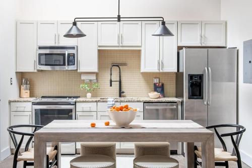 a kitchen with a table with a bowl of oranges on it at Beltline Shrine in Atlanta