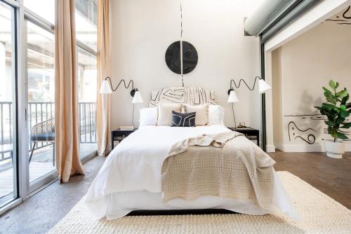 a bedroom with a white bed and a large window at Beltline Shrine in Atlanta