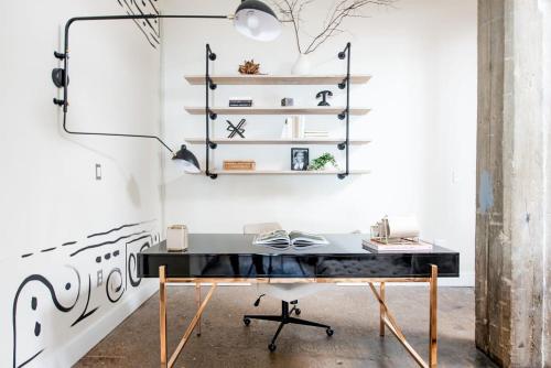 a desk in a room with a white wall at Beltline Shrine in Atlanta