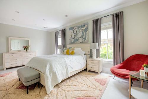 een slaapkamer met een groot bed en een rode stoel bij Creme Carmel in Atlanta