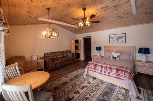 a bedroom with a bed and a living room at The Snowshoe Lodge in Lake Placid