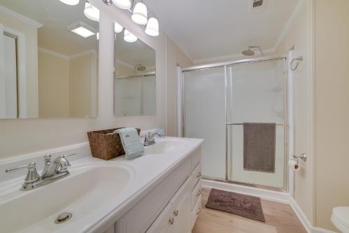 a white bathroom with a sink and a shower at Stanardsville Cabin Rental about 24 Mi to Shenandoah! in Stanardsville