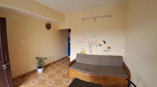 a room with a bench in the corner of a room at Anand Niketan Homestay Shimla in Shimla