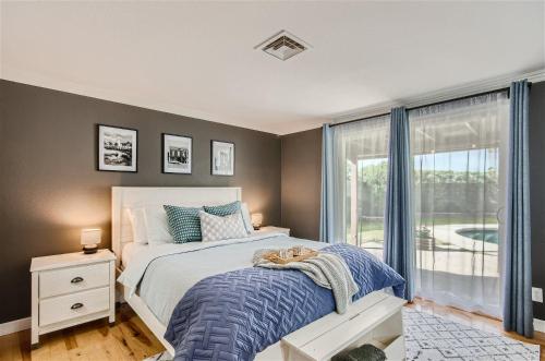 a bedroom with a bed and a large window at Arizona Daydream with Private Pool plus EV Charger in Chandler