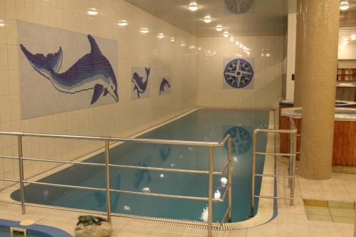 a large swimming pool in a building with at Wellness Hotel Szindbád in Balatonszemes