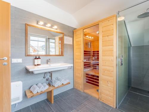 a bathroom with a sink and a shower at Chalet Bergblick in Sankt Margarethen im Lungau