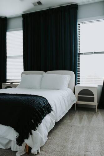 a bedroom with a large bed with black and white pillows at Winner's Circle in The City in Lexington