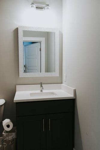 a bathroom with a sink and a mirror at Winner's Circle in The City in Lexington