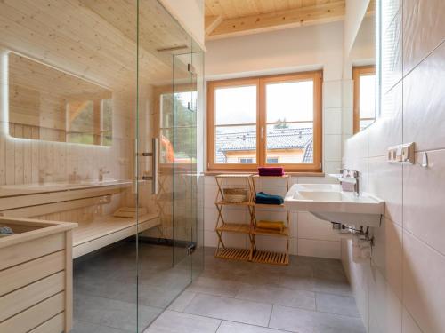 a bathroom with a glass shower and a sink at Haus Rapunzel in Donnersbachwald