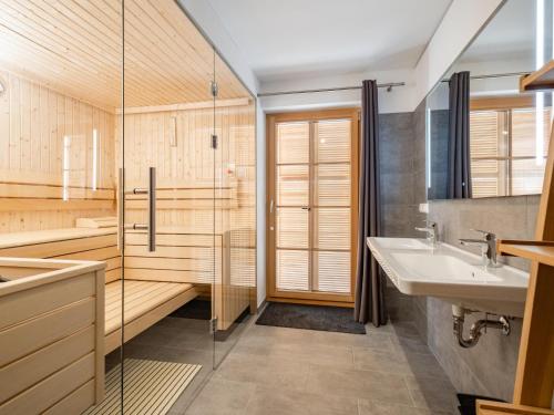 a bathroom with a glass shower and a sink at Steier Hütte S in Donnersbachwald