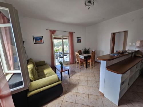 a living room with a couch and a table at Apartments with a parking space Slano, Dubrovnik - 8540 in Slano