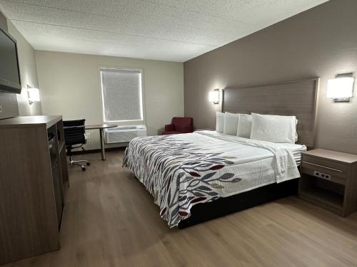 um quarto de hotel com uma cama e uma secretária em Red Roof Inn Richmond, VA - W Broad St em Richmond