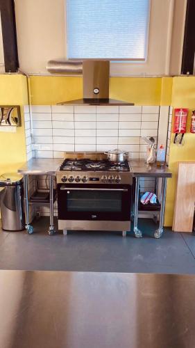 a kitchen with a stove and a table in it at Mount Hope Estate Vineyard in Dixons Creek