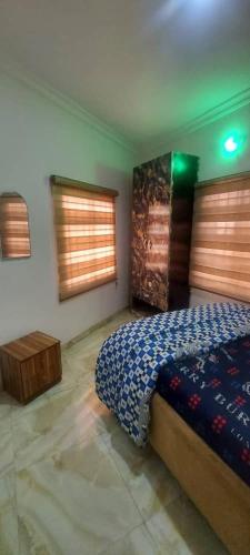 a bedroom with a bed and two windows at Nasaplace Venture in Badore