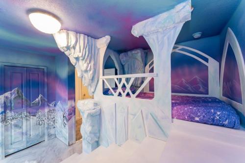 a bedroom with a bed in a room with a ceiling at Amazing 8br w pool theater game room by Disney in Kissimmee