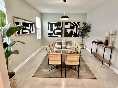 a dining room with a table and chairs at Amazing 6br w pvt pool game room near Disney in Kissimmee
