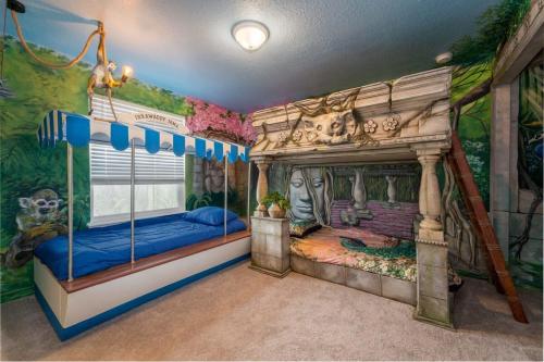 a room with two beds in a room with a mural at Luxurious New 9BR Villa w Game Room Theater Pool in Davenport