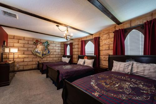 a bedroom with two beds in a room at Charming 9BR Villa w Theme & Game Rooms by Disney in Kissimmee