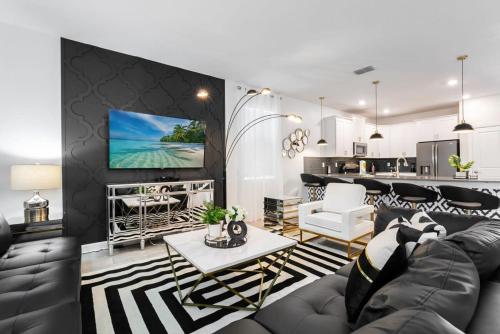 a living room with a couch and a table at Magical 9BR Villa by Disney w Pool Theme Room in Kissimmee