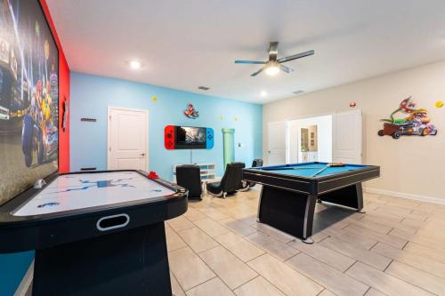 a room with a pool table and a tv at Magical 9BR Villa by Disney w Pool Theme Room in Kissimmee