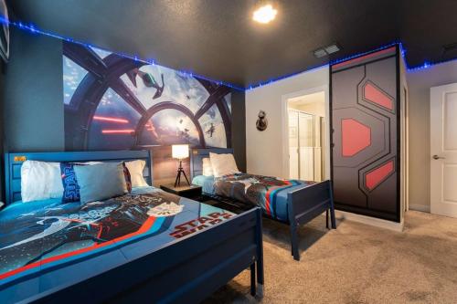 a room with two beds and a painting on the wall at Magical 9BR Villa by Disney w Pool Theme Room in Kissimmee