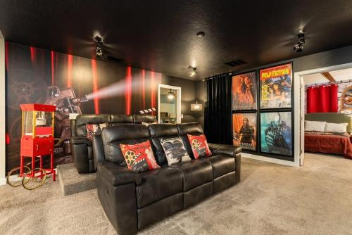 a living room with a leather couch and a bed at Magical 9BR Villa by Disney w Pool Theme Room in Kissimmee