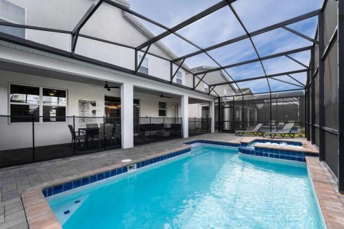 an indoor swimming pool with a glass ceiling at Magical 9BR Villa by Disney w Pool Theme Room in Kissimmee