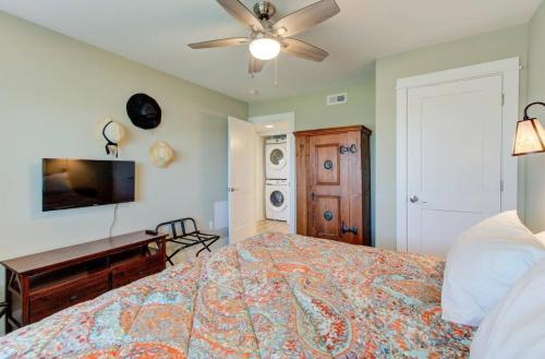 a bedroom with a bed and a ceiling fan at Carolina Surf - 3BR Condo with Stunning Ocean Views in Carolina Beach