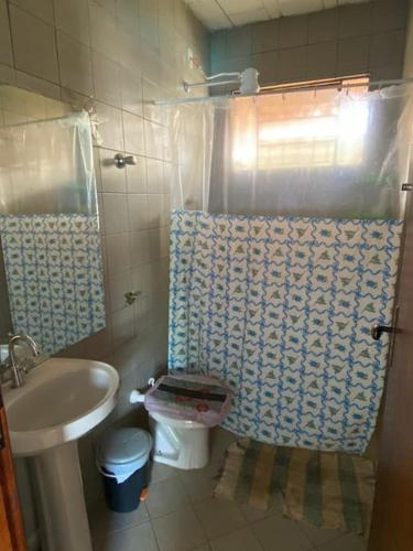 a small bathroom with a toilet and a sink at Casa das orquídeas in Santana do Riacho