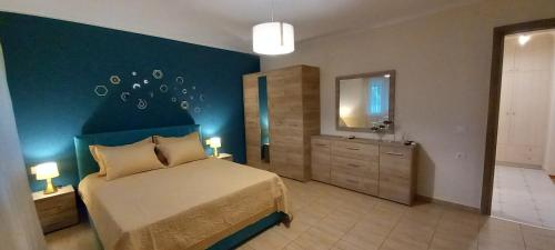a bedroom with a bed and a mirror and a sink at ARMONIA HOUSE in Vromerí