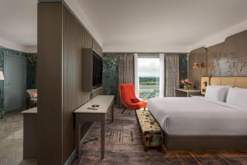 a hotel room with a bed and a desk and a window at Crowne Plaza Dublin Blanchardstown by IHG in Blanchardstown