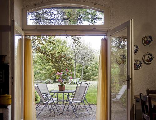 an open door to a patio with a table and chairs at Cà Morari in Argenta