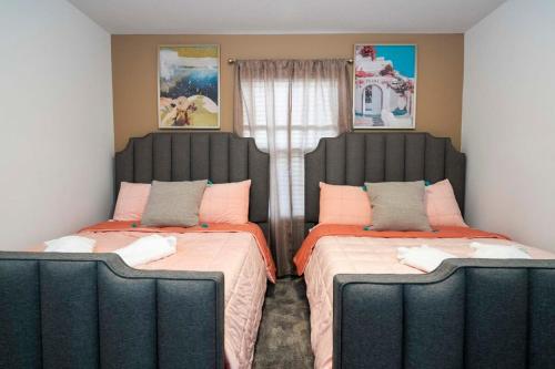 two beds sitting next to each other in a room at WonderFull 4Bd with Pool at Champions Gate 1174 in Kissimmee