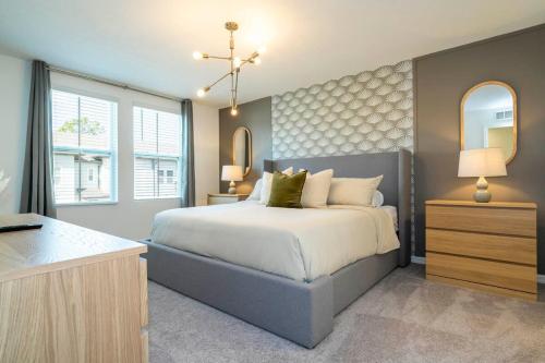 a bedroom with a bed and a dresser and a mirror at Charming 3Bd Close to Disney at Enclave 1021 in Davenport