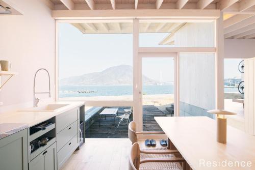 a kitchen with a view of the ocean at WAKKA in Imabari