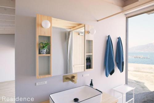 a bathroom with a sink and a mirror at WAKKA in Imabari