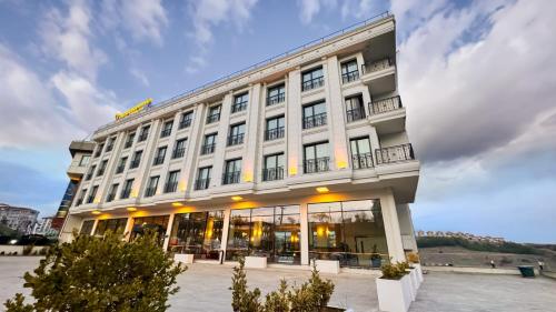 a large white building with a lot of windows at KANYON VADİ HOTEL in Bostanbükü