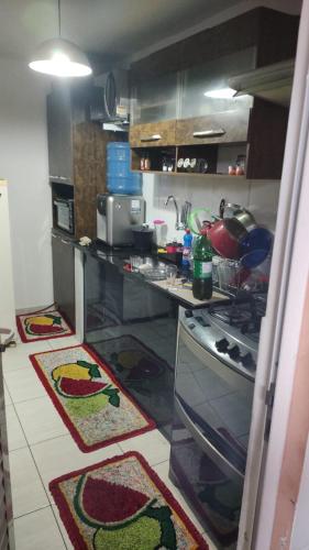 a kitchen with two rugs on the floor at Casa 2 quartos na Taquara -Duque de Caxias in Duque de Caxias