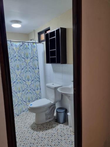 a bathroom with a toilet and a sink at El Rinconcito de la Antigua in Antigua Guatemala