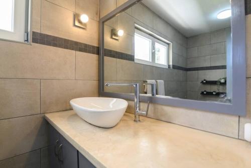 a bathroom with a bowl sink and a mirror at Casa Mango- Mountain & Sea Panoramic view - 3Bedrooms in San Felipe de Puerto Plata