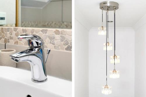 ロンドンにあるChic 3BR Home - Eats and Sights Closebyの蛇口と鏡が付いたバスルームのシンク
