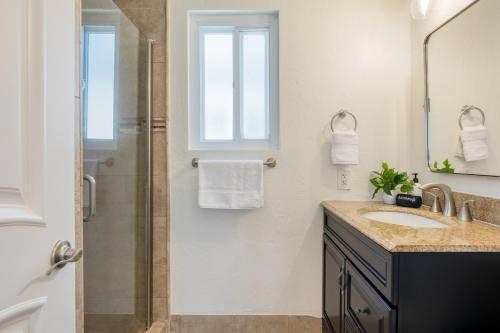 a bathroom with a sink and a shower at Surfrider II by AvantStay Walk to the Beach Balcony in Newport Beach